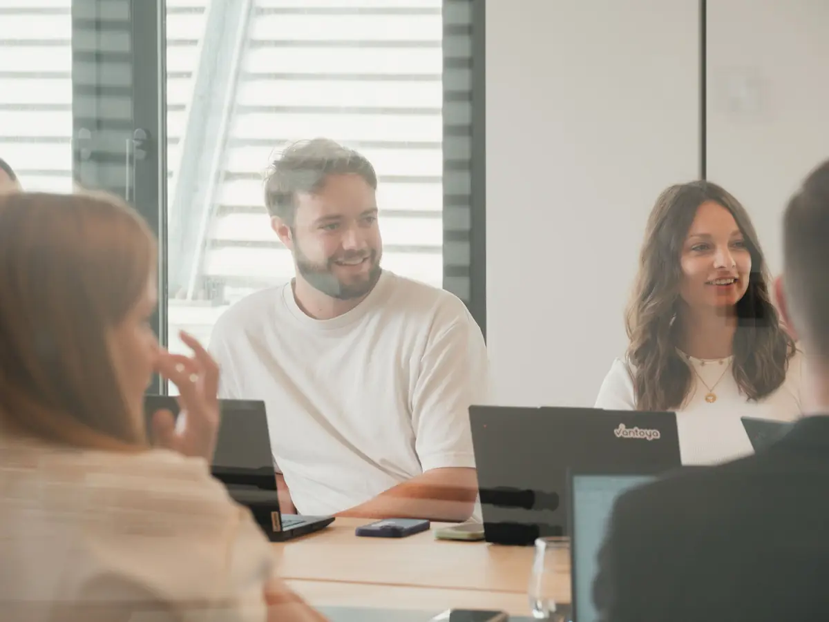 The team laughing together around the meeting table